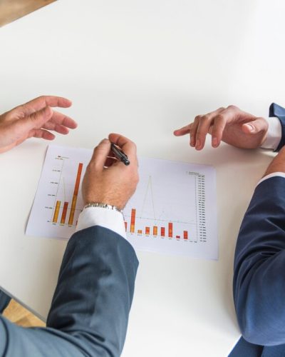 close-up-businessmen-working-company-financial-report-white-desk_23-2147857302